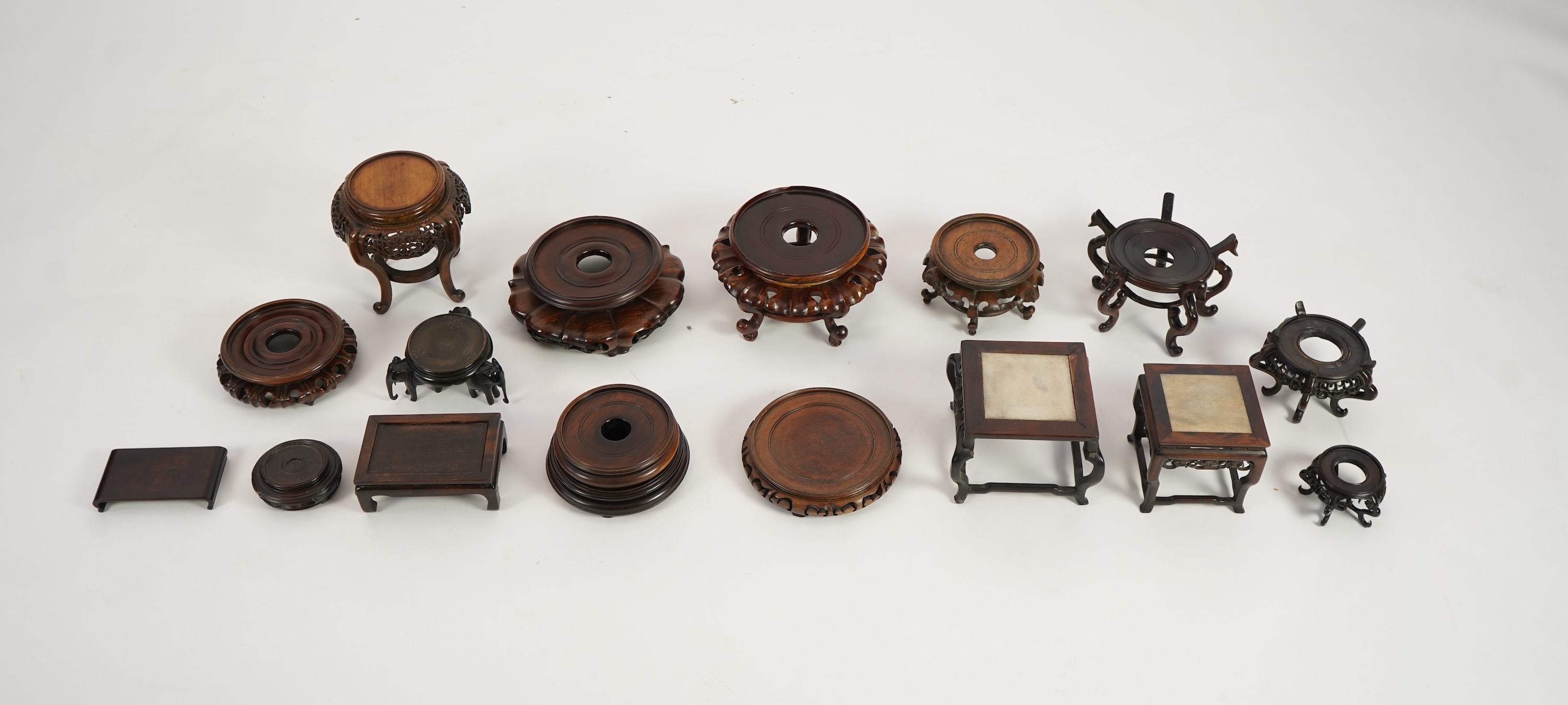 A group of sixteen Chinese hardwood stands together with a Japanese stand, 19th/20th century